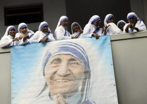 Members of the Missionaries of Charity attend a service marking the 100th anniversary of the birth of Blessed Teresa of Kolkata in this Aug. 26, 2010, file photo. Pope Francis has approved a miracle attributed to the intercession of Blessed Teresa, paving the way for her canonization in 2016. (CNS photo/Deshakalayan Chowdhur, Reuters pool) See MOTHER-TERESA-SAINTHOOD-CAUSES Dec. 18, 2015.